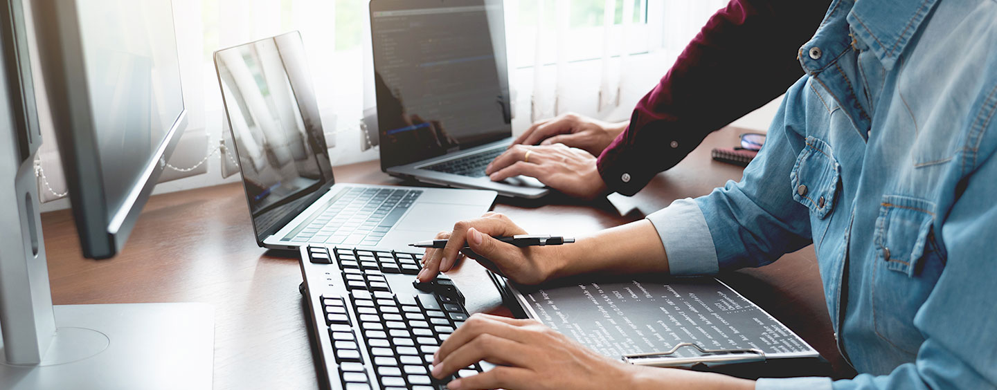 Photo of a person typing on a keyboard