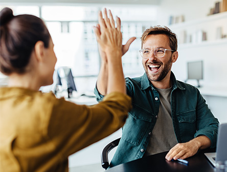 two people celebrating their achievements at work