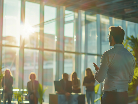 A man talking to colleagues about dedication to sustainability goals