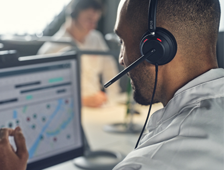 A Man wearing an EPOS IMPACT Line headset at work