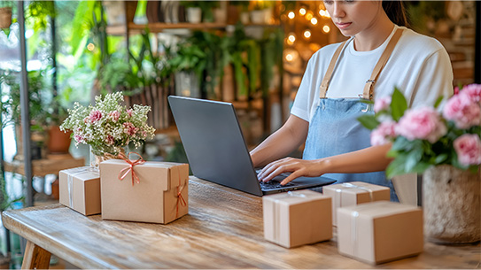 A person using a laptop at work in their small business