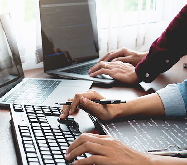 Photo of a person typing on a keyboard